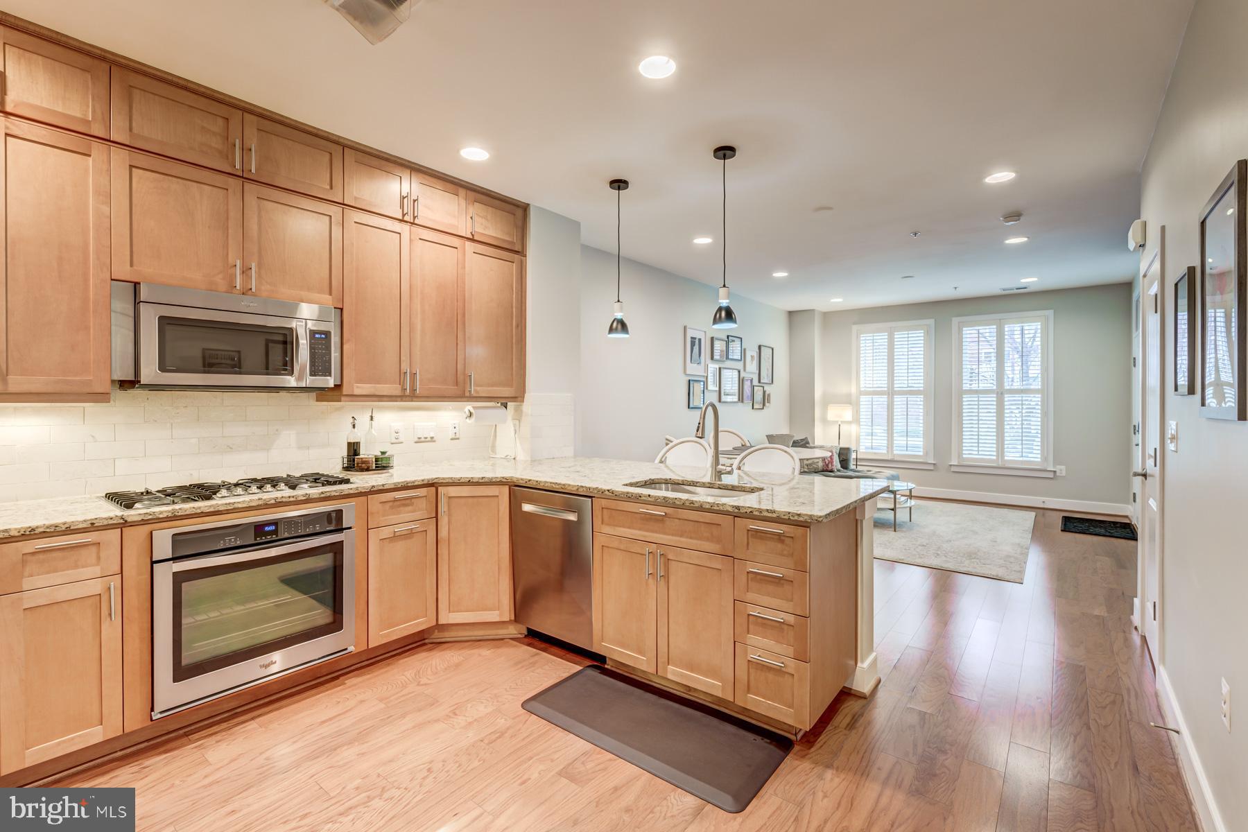 2207 Main Line Boulevard, Unit 101 Alexandria, VA 22301 - Photo 12 of 46 a kitchen with a stove a sink and a microwave