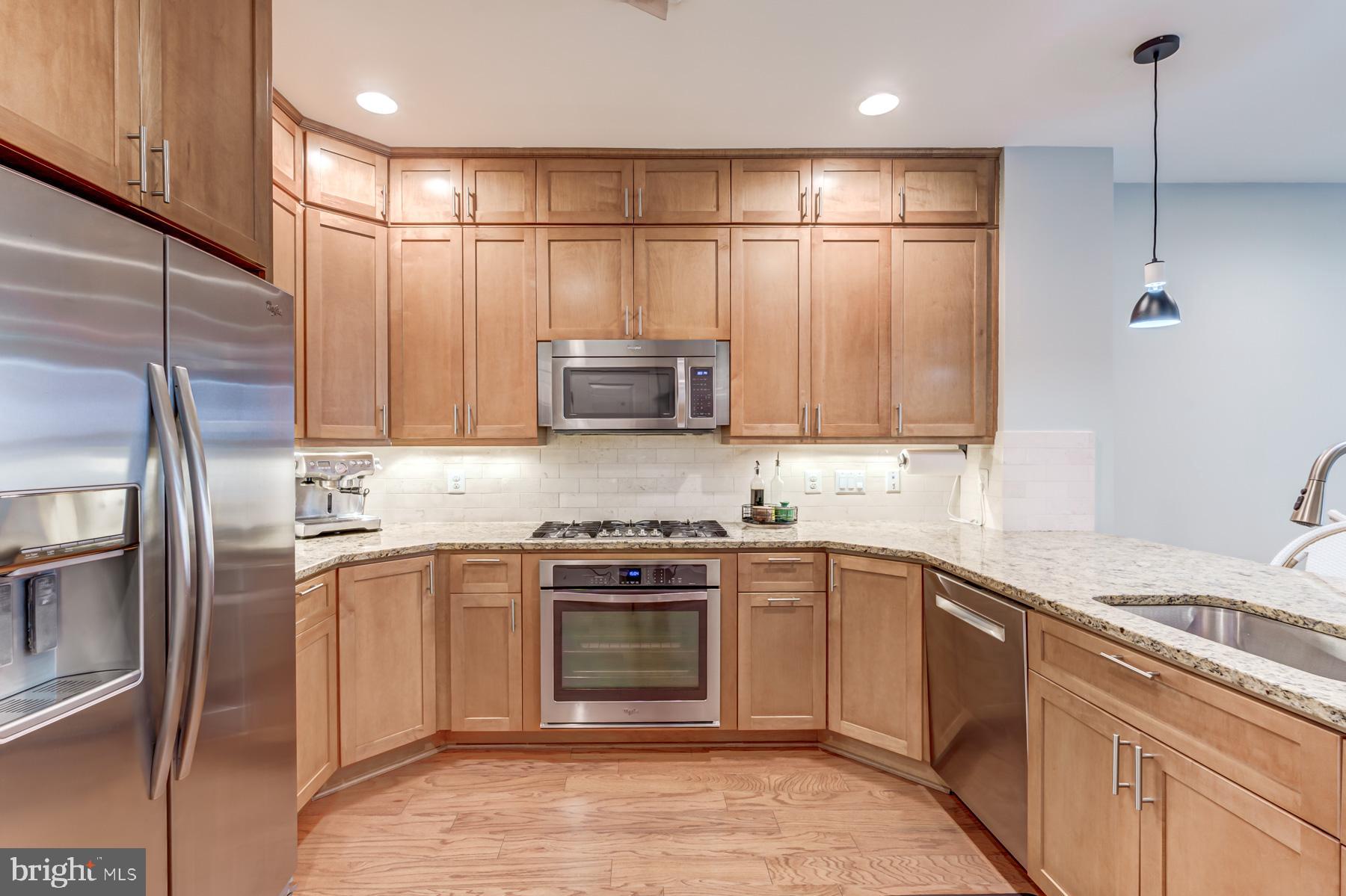 2207 Main Line Boulevard, Unit 101 Alexandria, VA 22301 - Photo 13 of 46 a kitchen with stainless steel appliances granite countertop a sink a stove a refrigerator and island