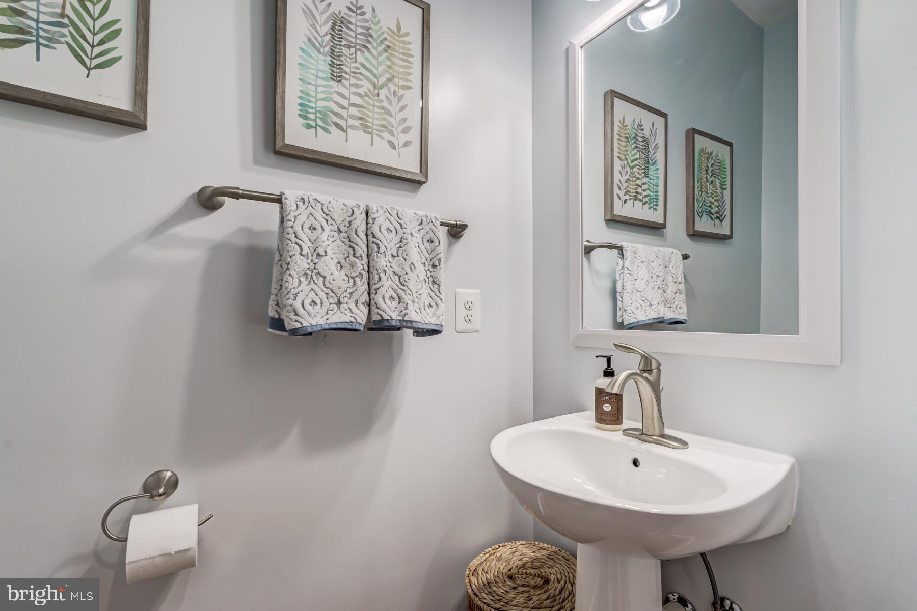 2207 Main Line Boulevard, Unit 101 Alexandria, VA 22301 - Photo 17 of 46 a bathroom with a sink a mirror and a toilet