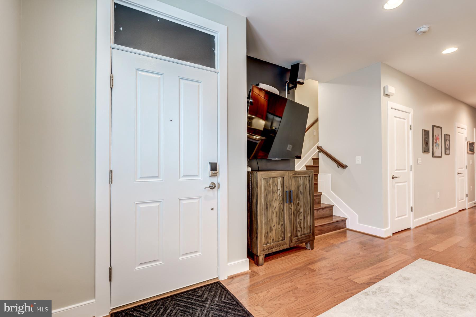 2207 Main Line Boulevard, Unit 101 Alexandria, VA 22301 - Photo 19 of 46 an entryway of a room with wooden floor and stairs