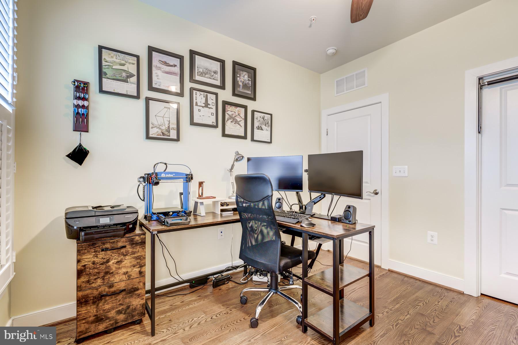 2207 Main Line Boulevard, Unit 101 Alexandria, VA 22301 - Photo 20 of 46 a workspace with furniture and painting on the wall