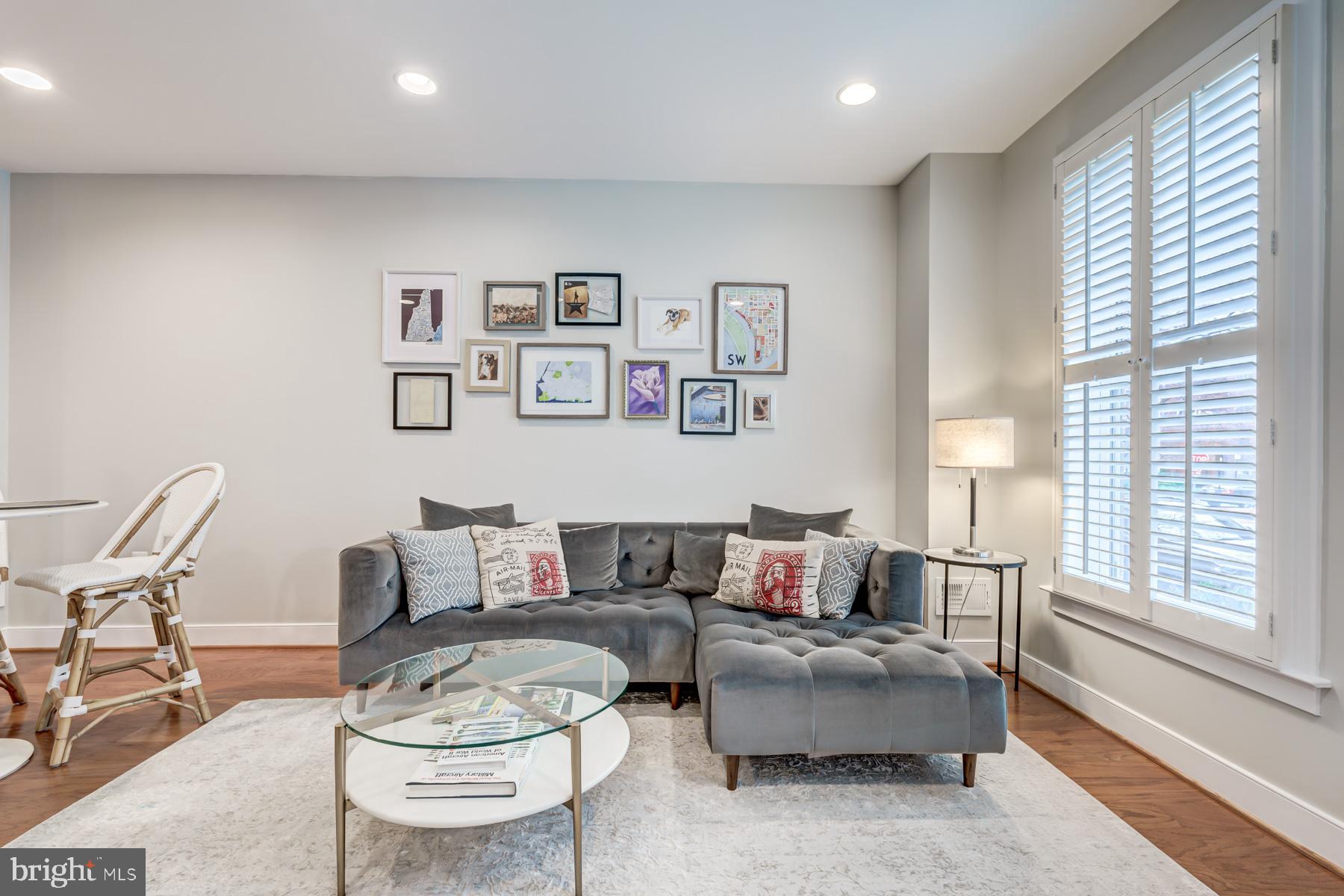 2207 Main Line Boulevard, Unit 101 Alexandria, VA 22301 - Photo 2 of 46 a living room with furniture and a large window