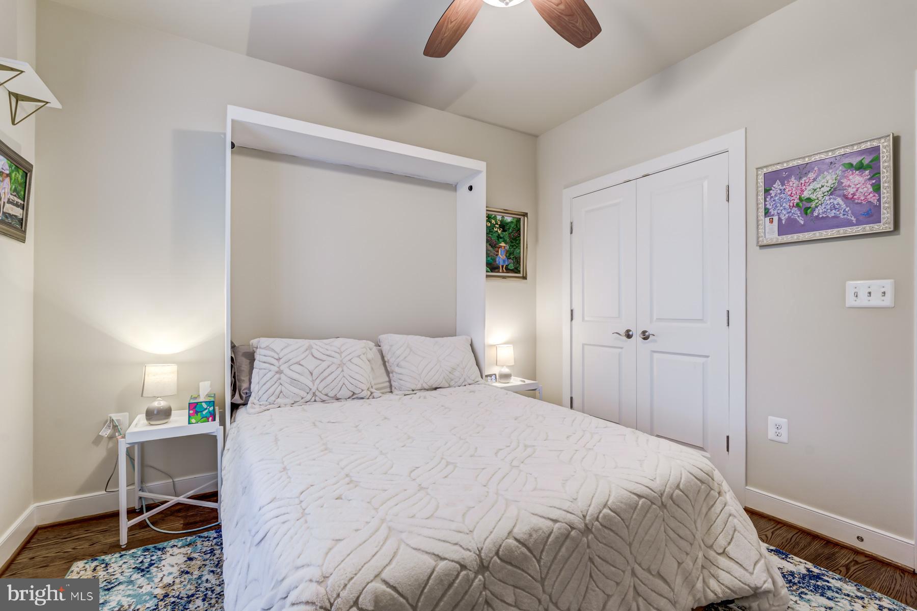 2207 Main Line Boulevard, Unit 101 Alexandria, VA 22301 - Photo 25 of 46 a bedroom with a bed and a chandelier