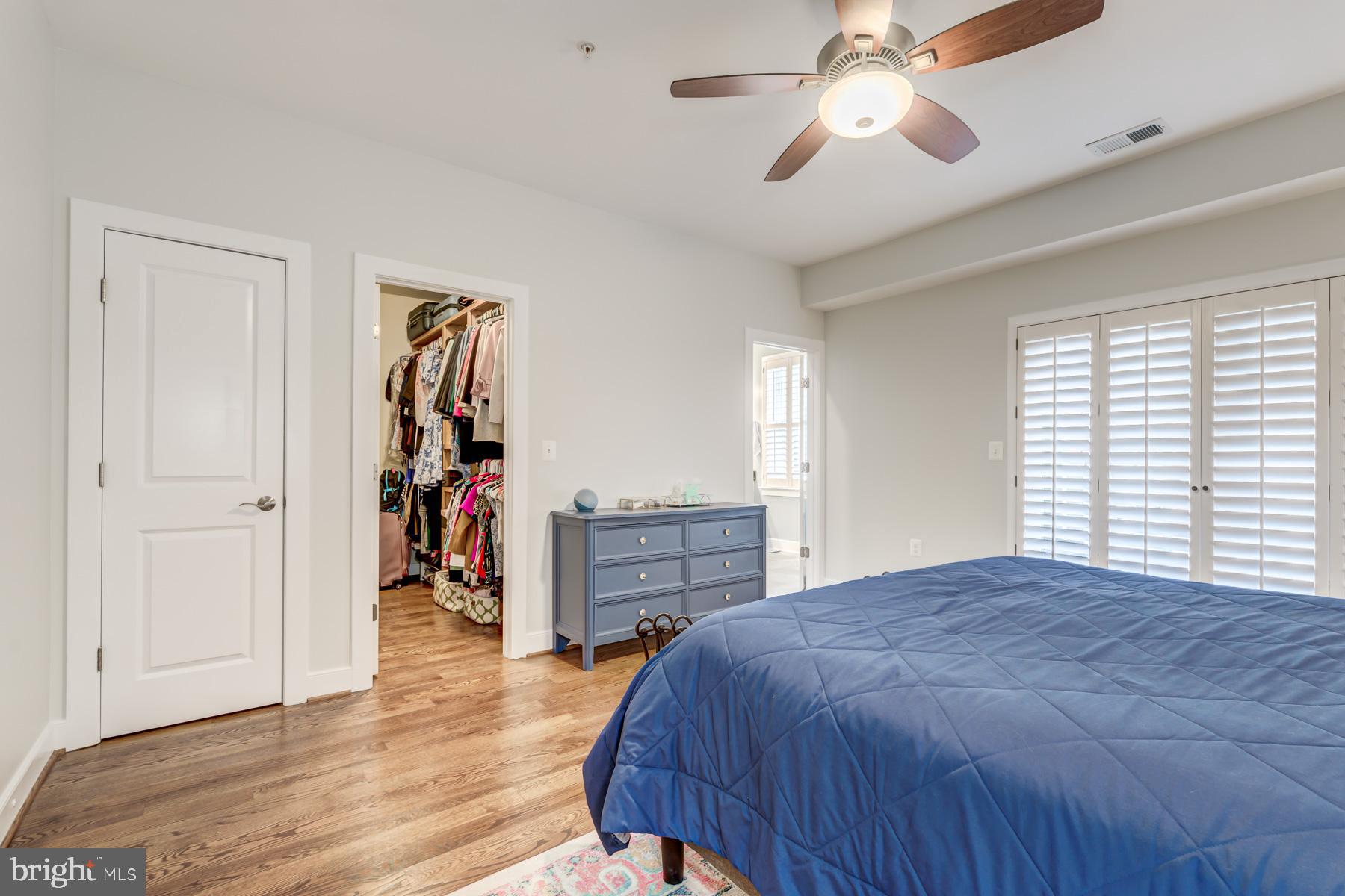 2207 Main Line Boulevard, Unit 101 Alexandria, VA 22301 - Photo 32 of 46 a bedroom with a bed and a chandelier