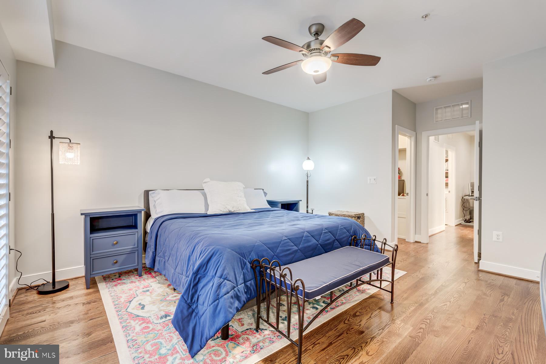 2207 Main Line Boulevard, Unit 101 Alexandria, VA 22301 - Photo 34 of 46 a bedroom with a bed a chandelier and a dresser