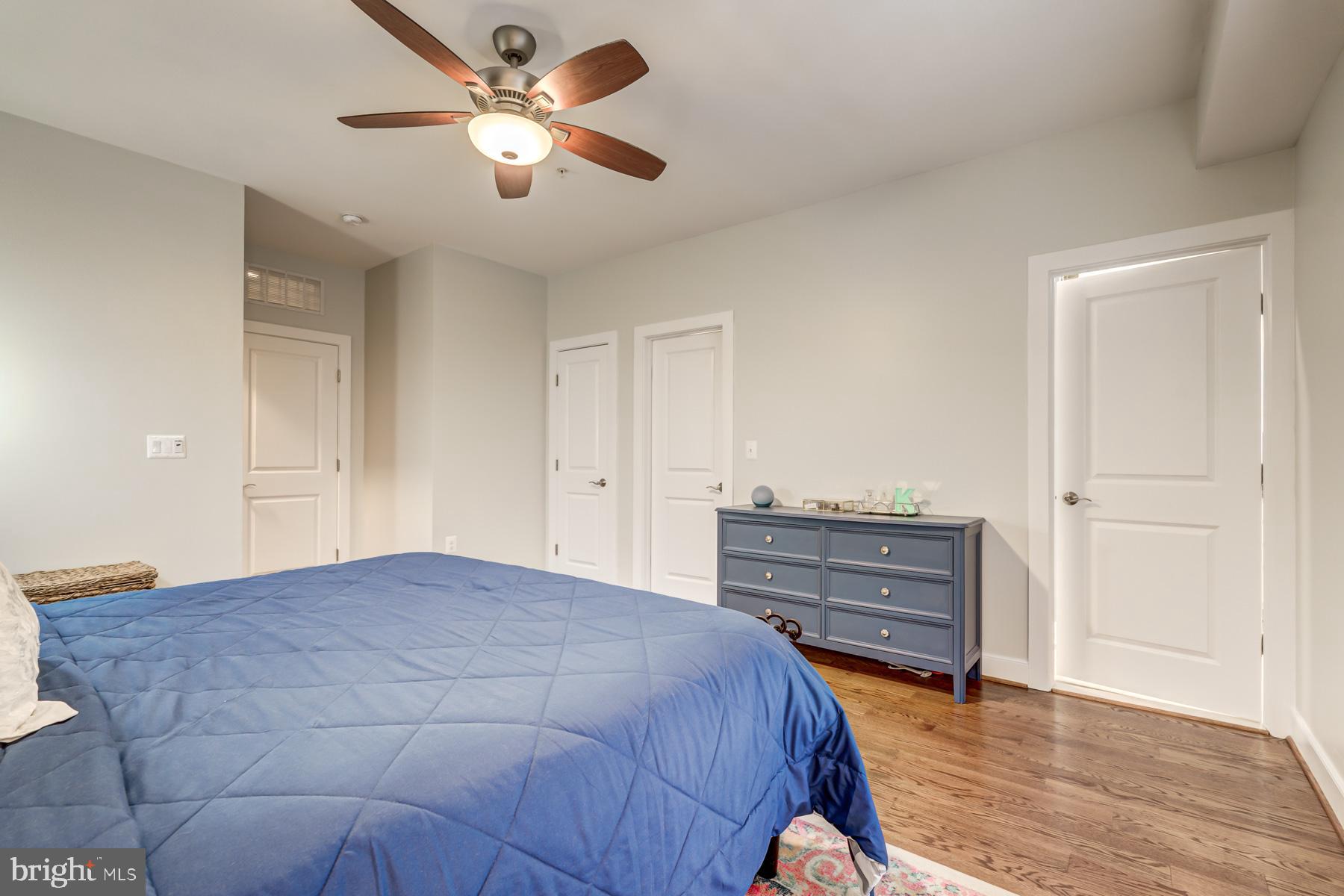 2207 Main Line Boulevard, Unit 101 Alexandria, VA 22301 - Photo 35 of 46 a bedroom with a bed and a chandelier