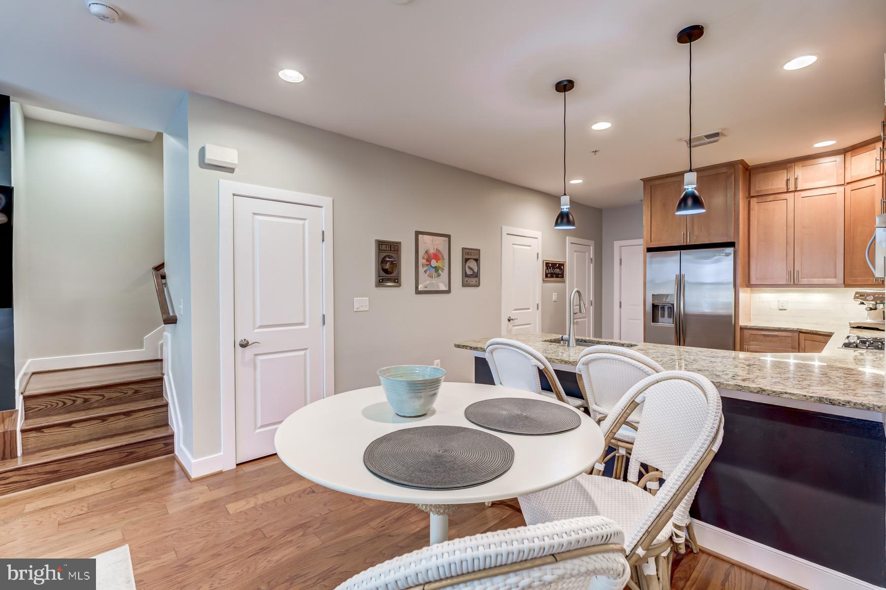 2207 Main Line Boulevard, Unit 101 Alexandria, VA 22301 - Photo 8 of 46 a dining room with granite countertop furniture and a wooden floor