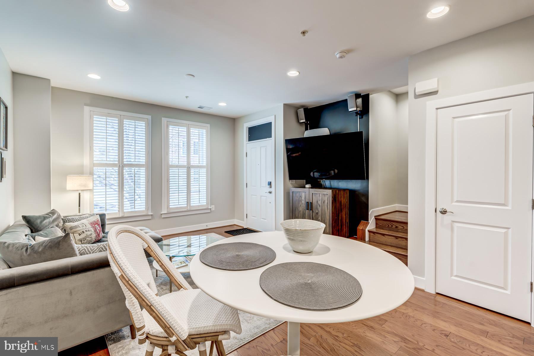 2207 Main Line Boulevard, Unit 101 Alexandria, VA 22301 - Photo 9 of 46 a view of a dining room with furniture window and wooden floor