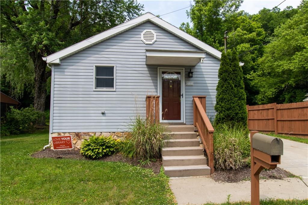 2111 Lewis Run Road Clairton, PA 15025 - Photo 2 of 17 a front view of a house with garden