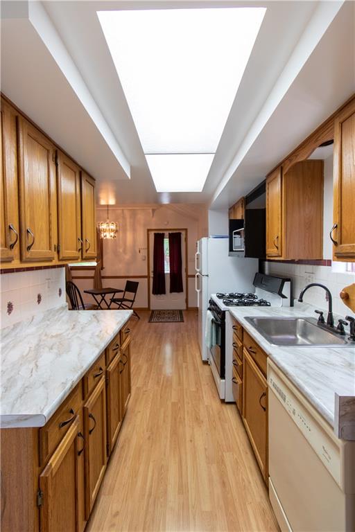 2111 Lewis Run Road Clairton, PA 15025 - Photo 6 of 17 a large kitchen with stainless steel appliances granite countertop wooden cabinets a stove top oven a sink and dishwasher