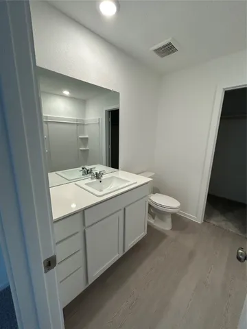 a bathroom with a double vanity sink and a mirror