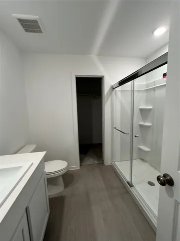a bathroom with a shower and a toilet