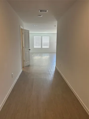 an empty room with a empty space and windows