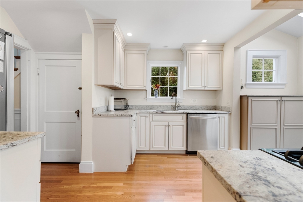 33 Ashcroft Road Medford, MA 02155 - Photo 11 of 30 a kitchen with granite countertop a sink cabinets and window