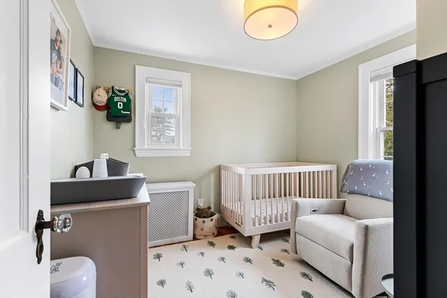 a bedroom with a large bed a flat tv screen and dresser