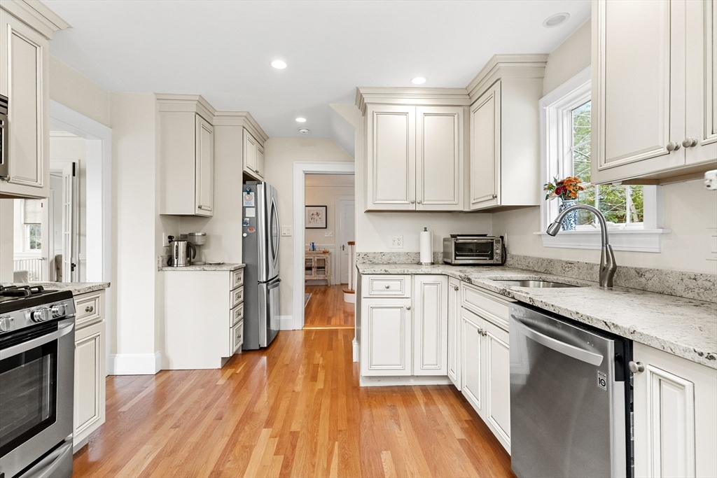 33 Ashcroft Road Medford, MA 02155 - Photo 7 of 30 a kitchen with stainless steel appliances granite countertop a stove a sink dishwasher and a refrigerator with wooden floor