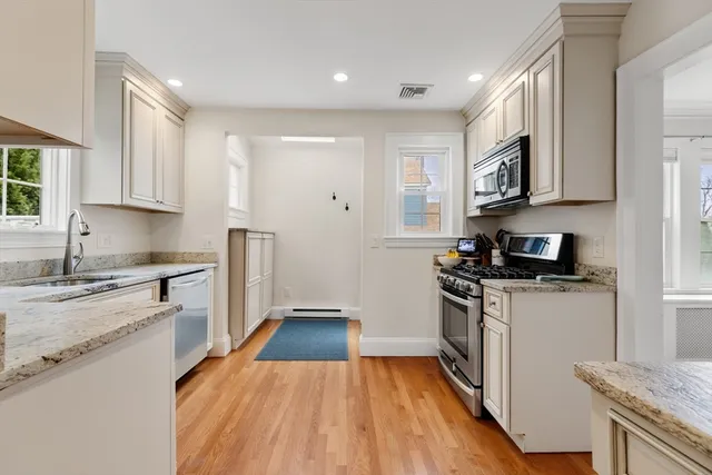 a kitchen with stainless steel appliances granite countertop a stove and a microwave