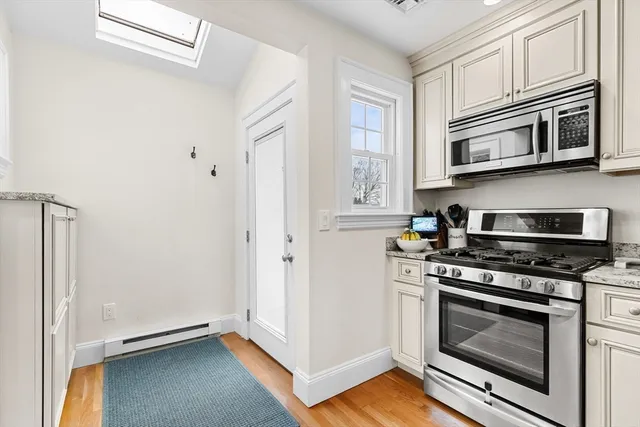 a kitchen with granite countertop a sink cabinets and window