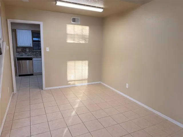 a view of an empty room and a window