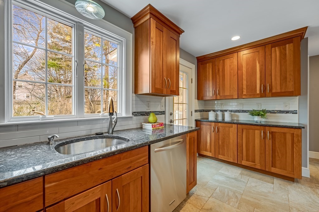 38 Cerdan Avenue Boston, MA 02132 - Photo 11 of 40 a kitchen with stainless steel appliances granite countertop a sink stove and cabinets