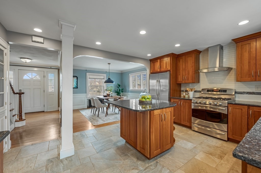 38 Cerdan Avenue Boston, MA 02132 - Photo 12 of 40 a kitchen with stainless steel appliances kitchen island granite countertop a stove refrigerator and cabinets