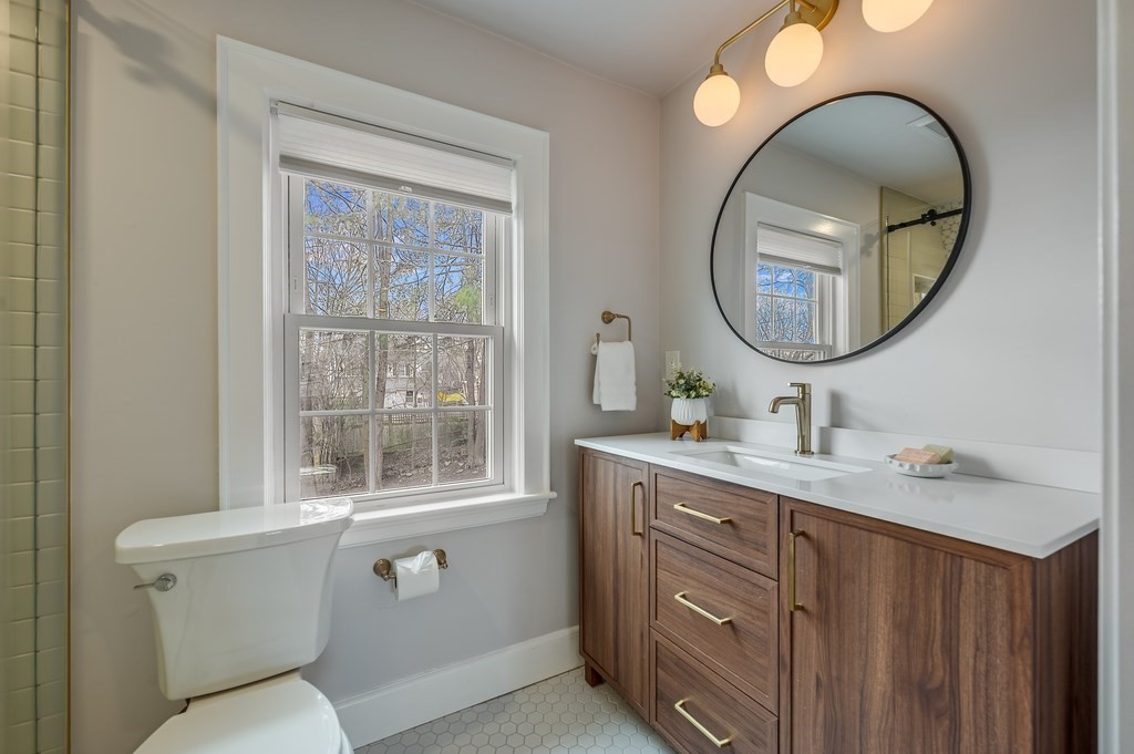 38 Cerdan Avenue Boston, MA 02132 - Photo 25 of 40 a bathroom with a toilet a sink and a mirror