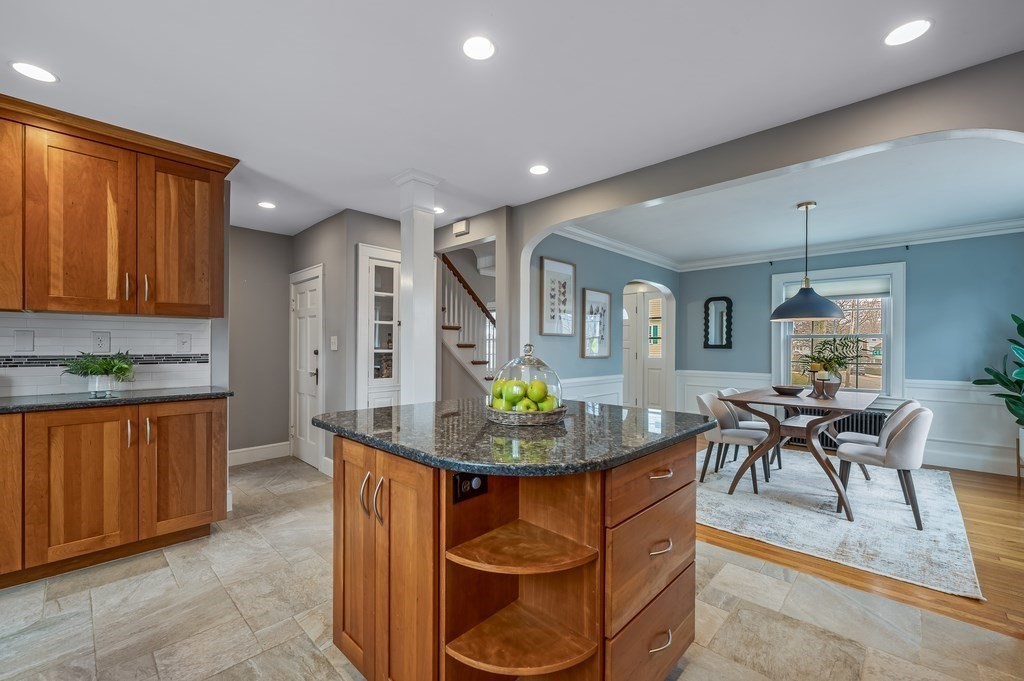 38 Cerdan Avenue Boston, MA 02132 - Photo 9 of 40 a kitchen with stainless steel appliances granite countertop a table and chairs in it