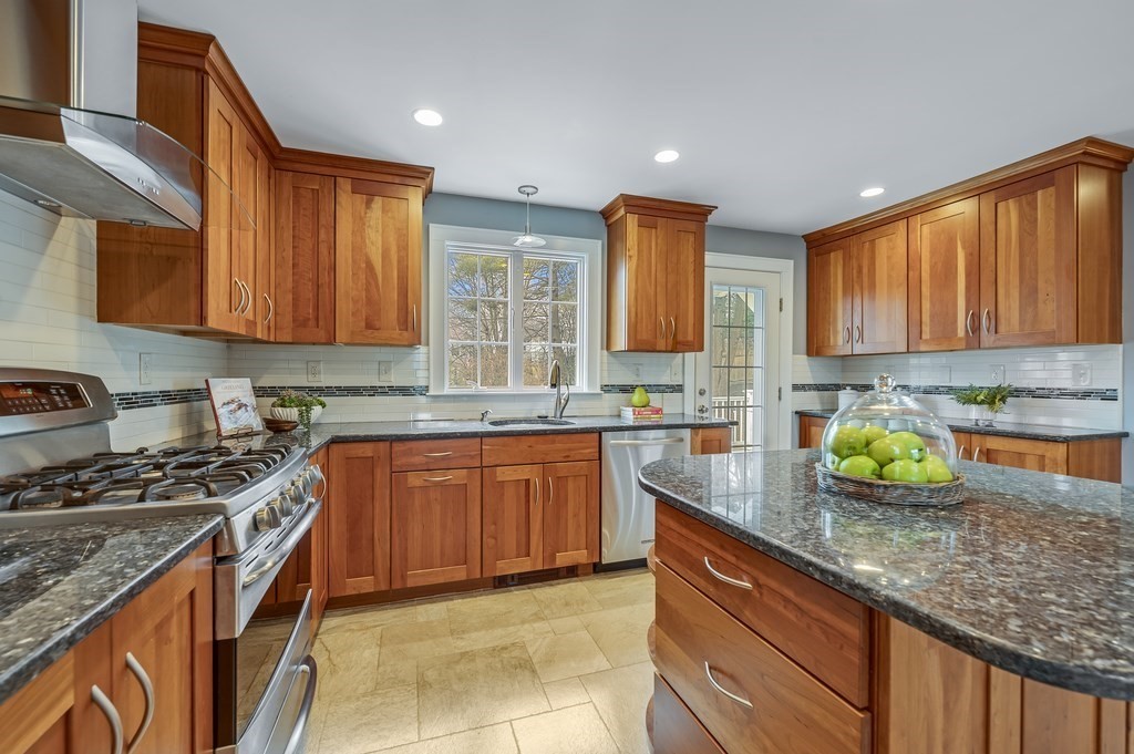 38 Cerdan Avenue Boston, MA 02132 - Photo 10 of 40 a kitchen with granite countertop stainless steel appliances a sink a stove top oven a counter space and cabinets