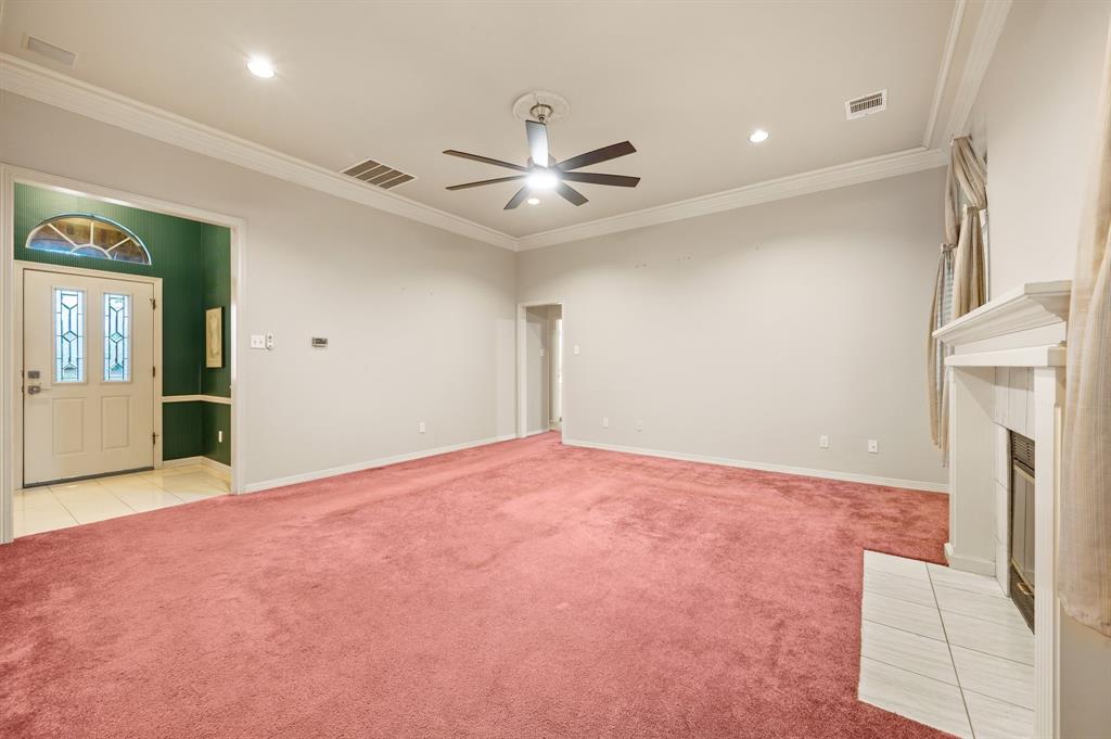 924 Hardie Street Hurst, TX 76053 - Photo 11 of 32 an empty room with chandelier fan and windows