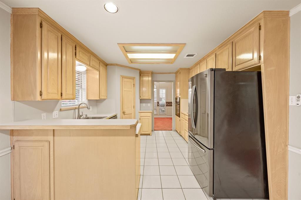 924 Hardie Street Hurst, TX 76053 - Photo 12 of 32 a kitchen with stainless steel appliances granite countertop a refrigerator and a sink