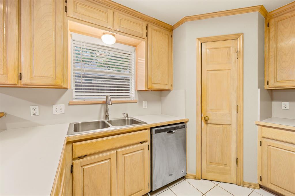 924 Hardie Street Hurst, TX 76053 - Photo 13 of 32 a kitchen with a sink cabinets and a window