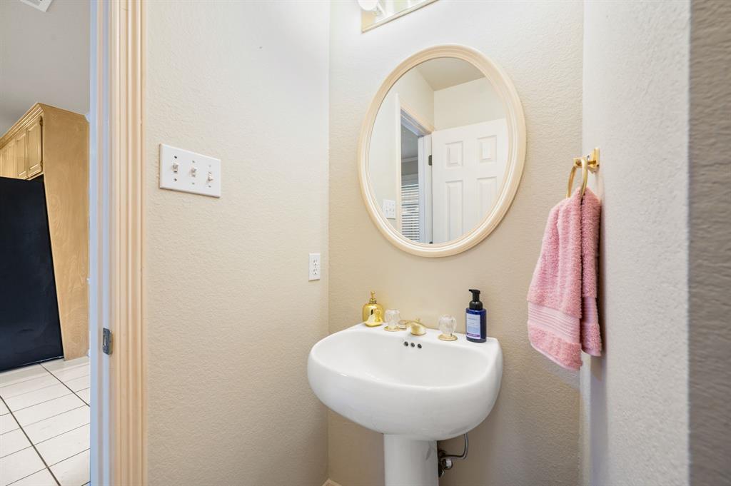 924 Hardie Street Hurst, TX 76053 - Photo 18 of 32 a bathroom with a sink and a mirror