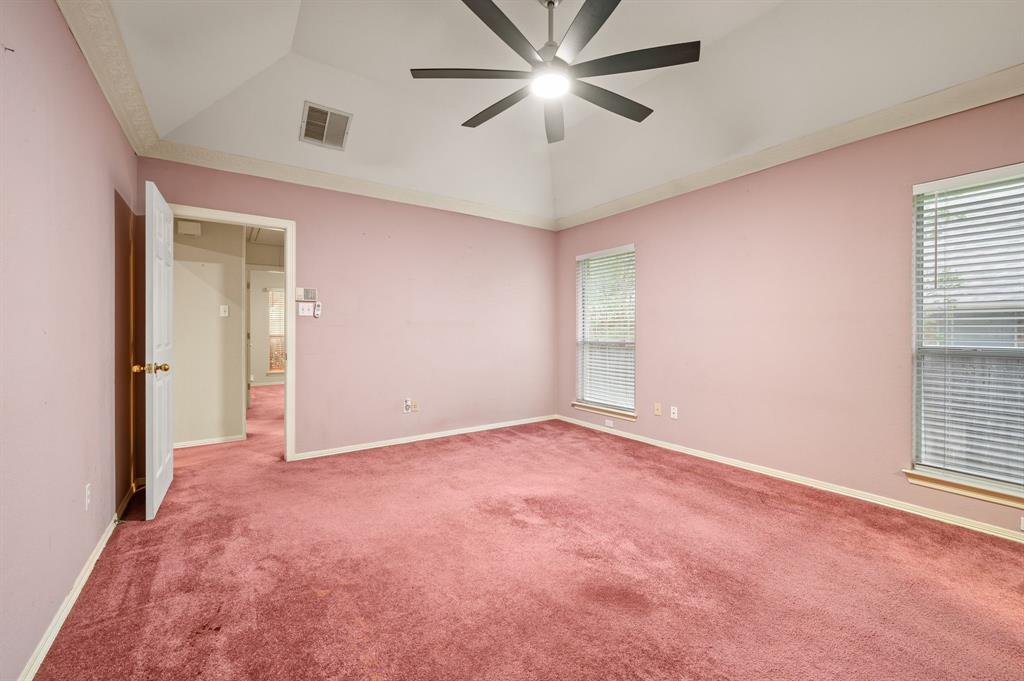924 Hardie Street Hurst, TX 76053 - Photo 20 of 32 an empty room with chandelier fan and windows