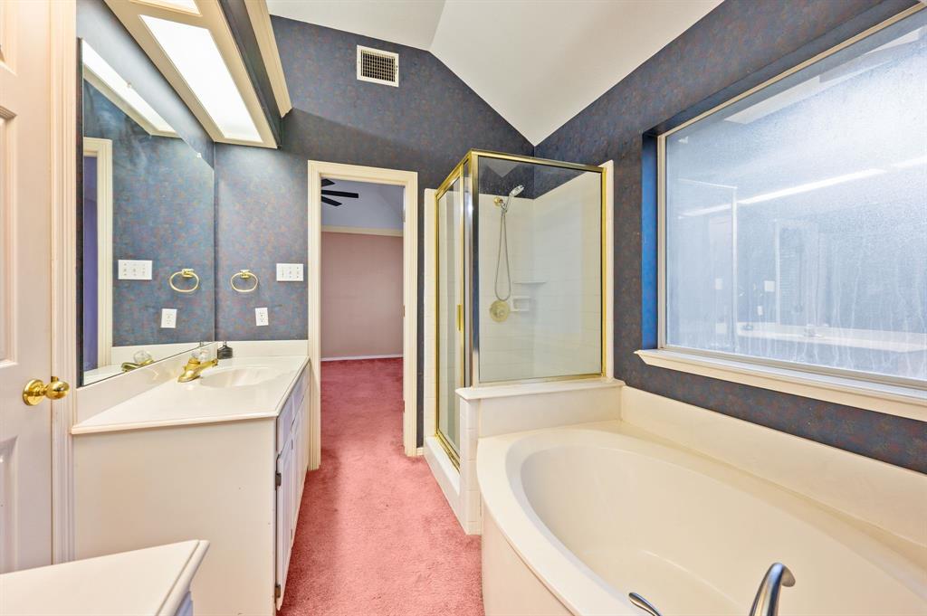 924 Hardie Street Hurst, TX 76053 - Photo 22 of 32 a spacious bathroom with a granite countertop tub sink and mirror