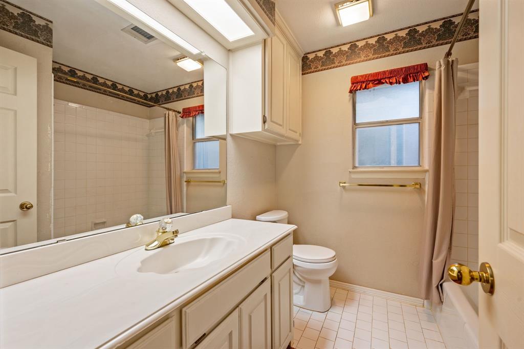 924 Hardie Street Hurst, TX 76053 - Photo 25 of 32 a bathroom with a sink a toilet and shower