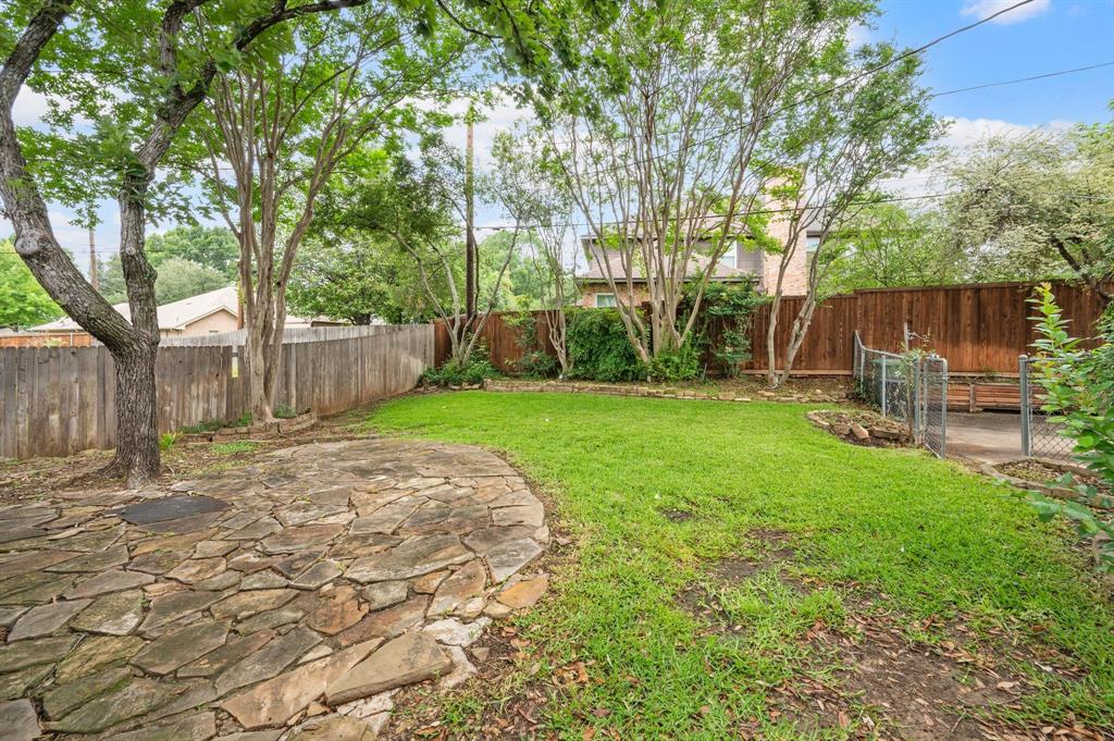924 Hardie Street Hurst, TX 76053 - Photo 29 of 32 a backyard of a house with table and chairs
