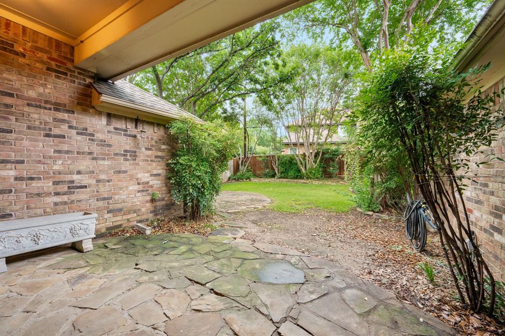 924 Hardie Street Hurst, TX 76053 - Photo 3 of 32 a view of backyard with plants and large trees