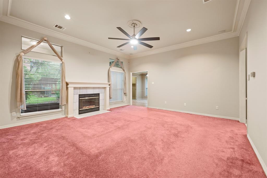 924 Hardie Street Hurst, TX 76053 - Photo 10 of 32 a view of an empty room with a fireplace and a window