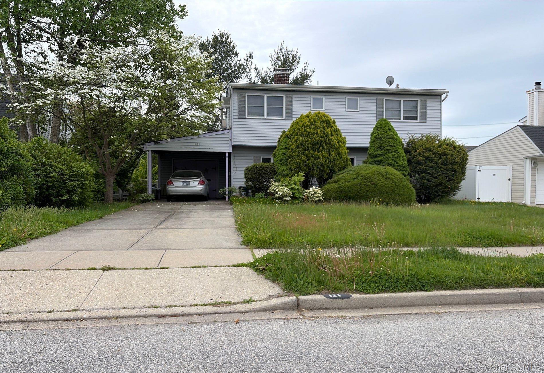 121 Farmedge Road Levittown, NY 11756 - Photo 2 of 4 a front view of a house with a yard and garage