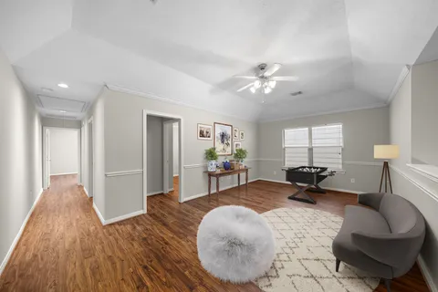 a living room with furniture and a chandelier