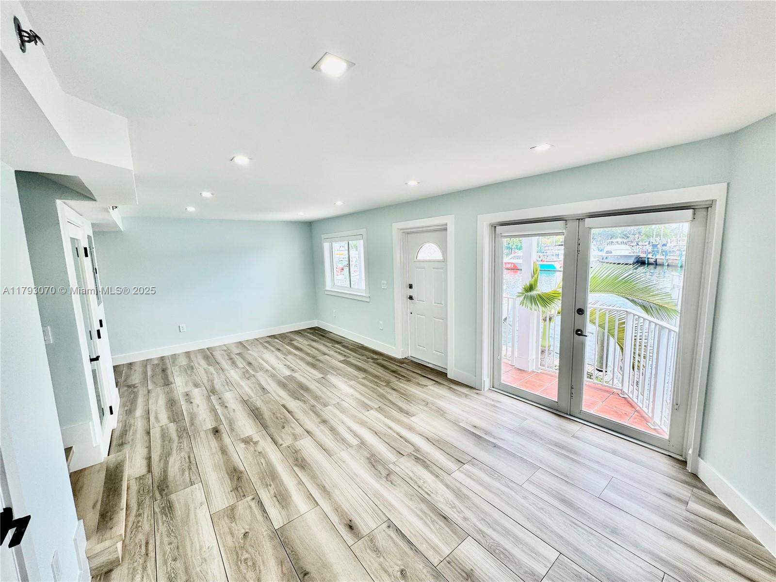 2415 Northwest 16th St Road, Unit 101 Miami, FL 33125 - Photo 11 of 36 wooden floor in an empty room with a window