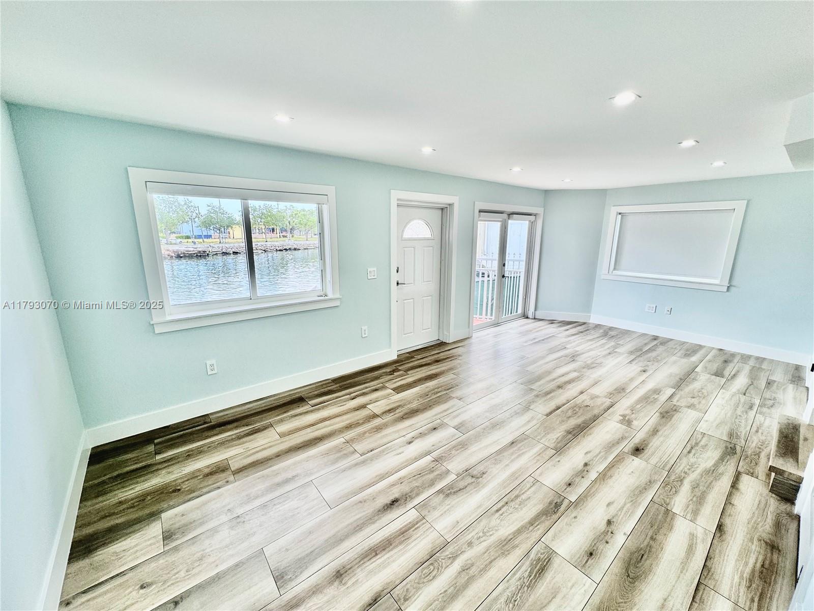 2415 Northwest 16th St Road, Unit 101 Miami, FL 33125 - Photo 16 of 36 a view of empty room with wooden floor