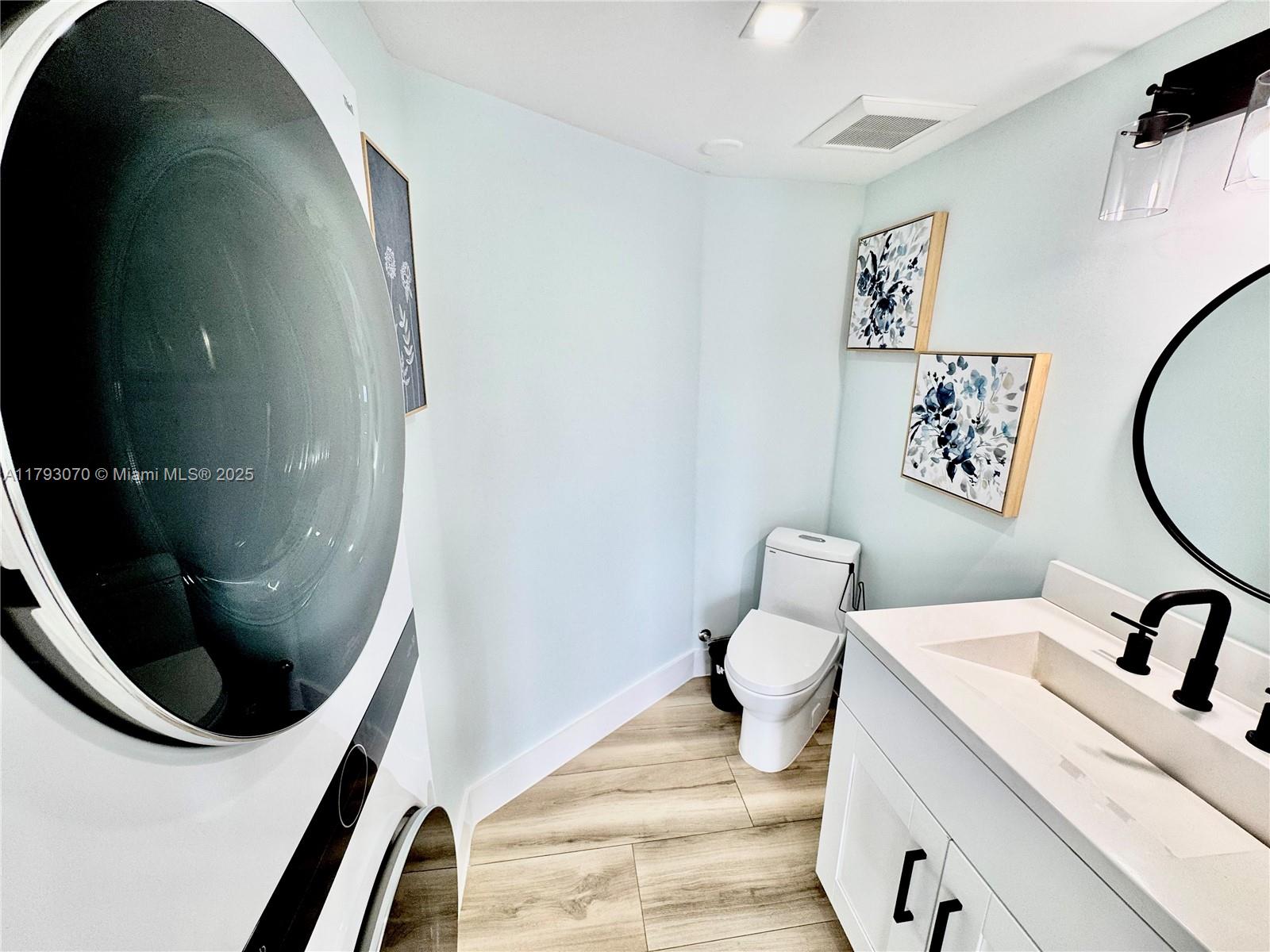 2415 Northwest 16th St Road, Unit 101 Miami, FL 33125 - Photo 19 of 36 a bathroom with a sink and a mirror