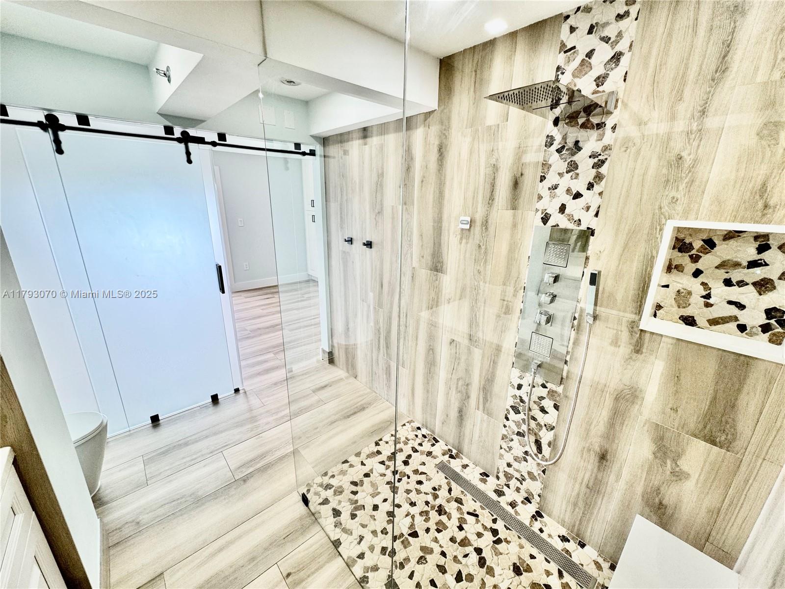 2415 Northwest 16th St Road, Unit 101 Miami, FL 33125 - Photo 25 of 36 a bathroom with a shower and a bathtub