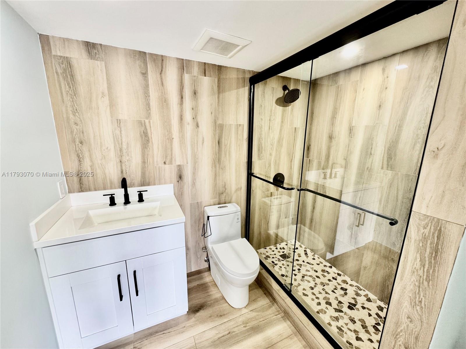 2415 Northwest 16th St Road, Unit 101 Miami, FL 33125 - Photo 34 of 36 a bathroom with a sink toilet and shower