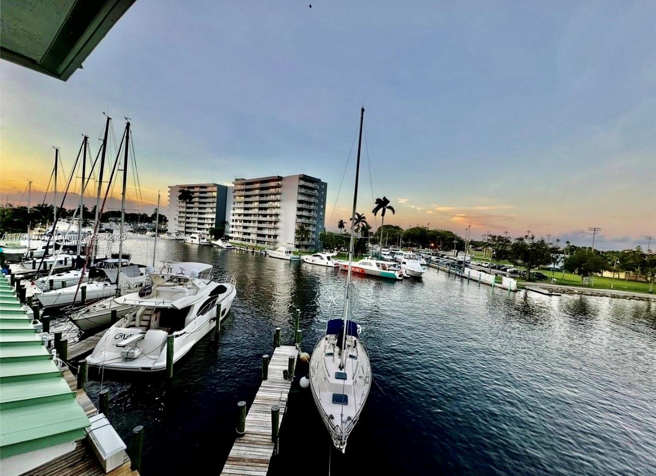 2415 Northwest 16th St Road, Unit 101 Miami, FL 33125 - Photo 7 of 36 a view of a lake with boats in front of house