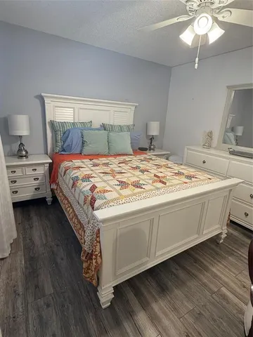 a spacious bedroom with a bed and a chandelier