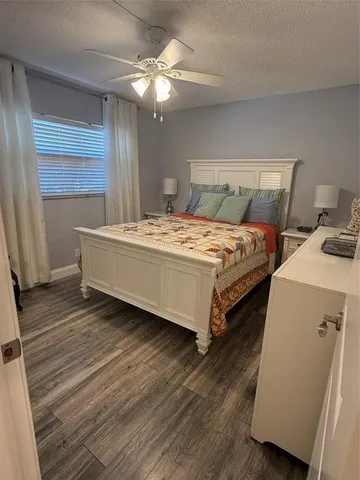 a spacious bedroom with a bed and a chandelier