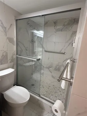 a bathroom with a shower and toilet