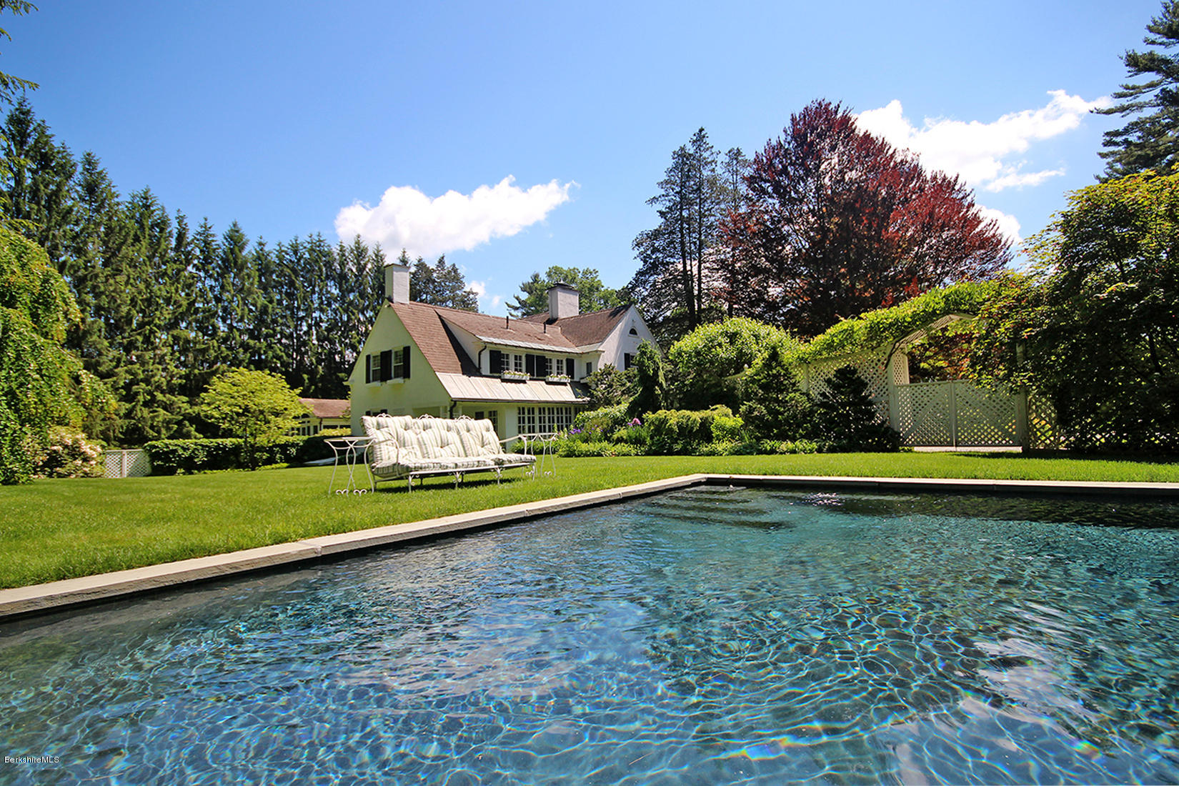 6 Glendale Road Stockbridge, MA 01229 - Photo 11 of 45 a view of a swimming pool with an outdoor space and seating area